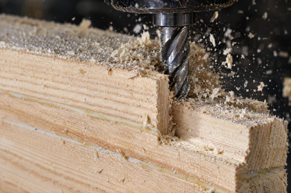 Close-up of a CNC end mill cutting a joint into glued laminated timber
